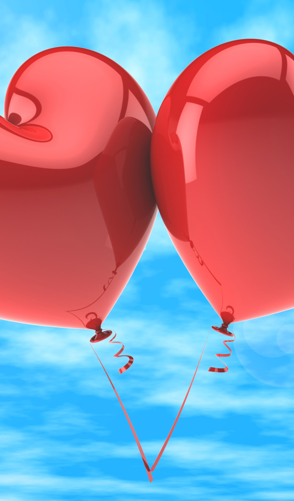 Два красных шарика в форме сердца в голубом небе
