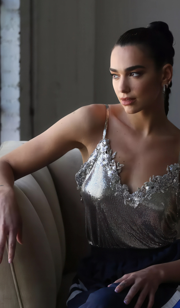 Певица Дуа Липа сидит у окна