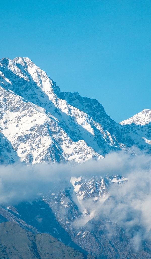 Высокие покрытые снегом горы на фоне голубого неба