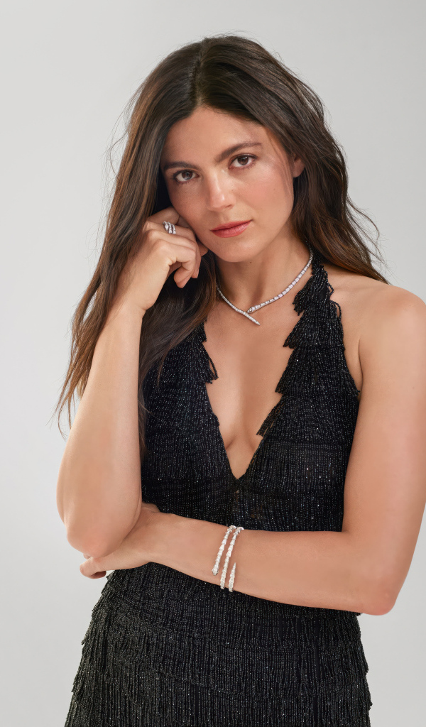 Актриса Моника Барбаро в черном платье на сером фоне