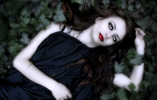 Девушка вампир лежит в листьях