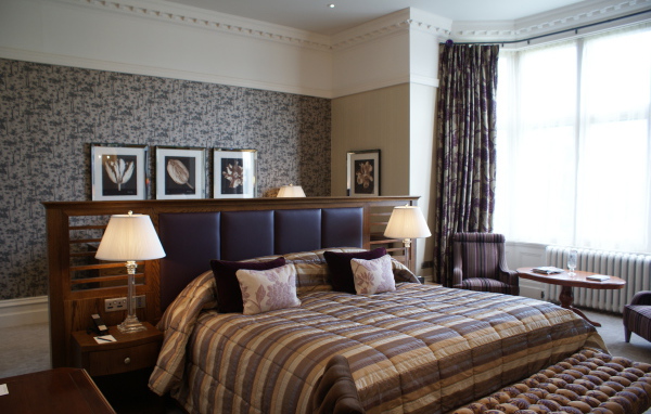 Большая кровать с кожаной спинкой