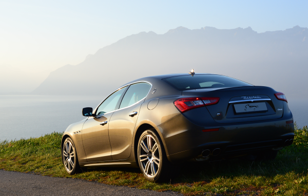 Коричневый Maserati на фоне гор