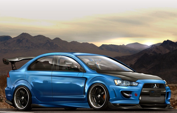 Голубой Mitsubishi Lancer Evo X на фоне гор