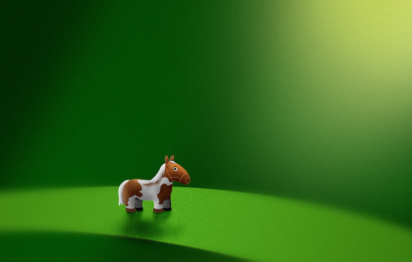 Игрушка лошадь на зеленом фоне