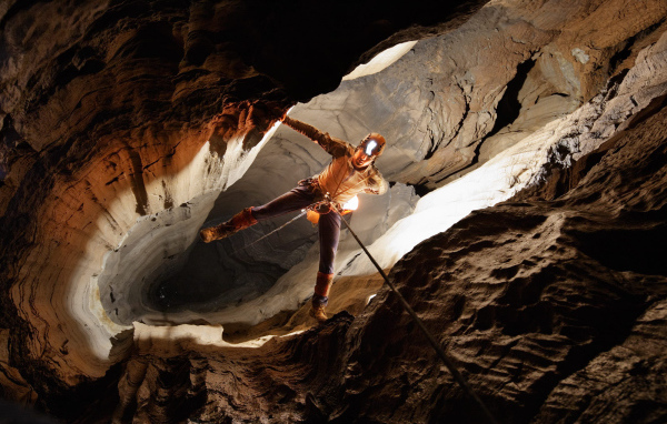 Человек спускается в пещеру