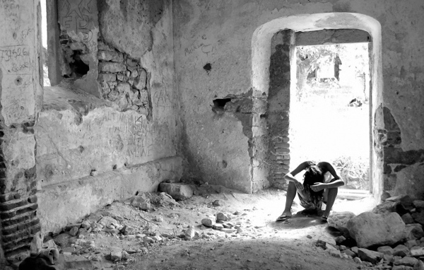 Человек на развалинах дома