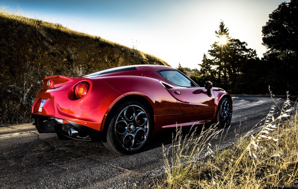 Красная Alfa Romeo 4C на повороте дороги