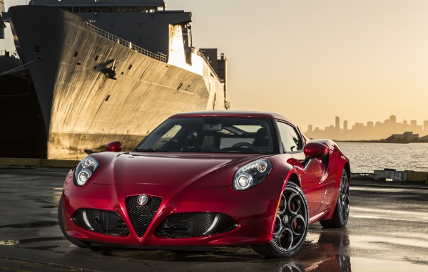 Red Alfa Romeo 4C on the background of the ship