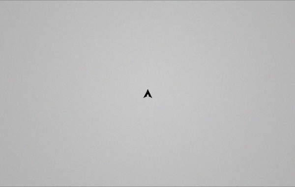 Маленький черный треугольник на сером фоне