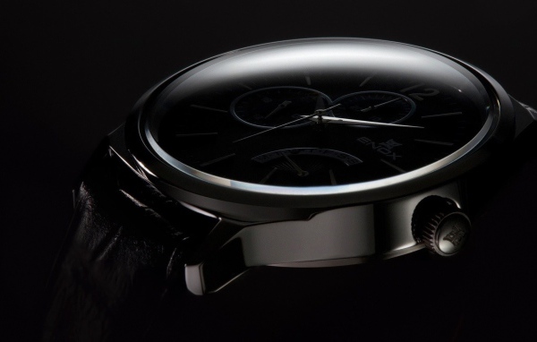 Дорогие черные часы на черном фоне