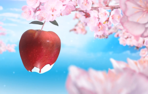 Красное яблоко среди розовых цветов