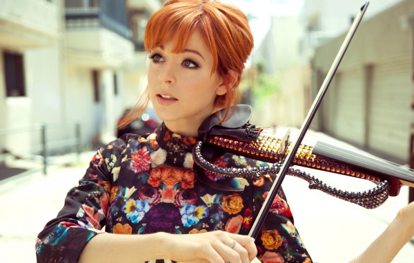 Рыжая девушка играет на скрипке со стразами