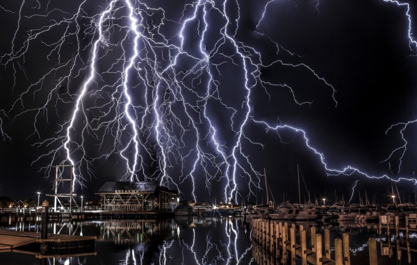 Молнии в черном небе над портом