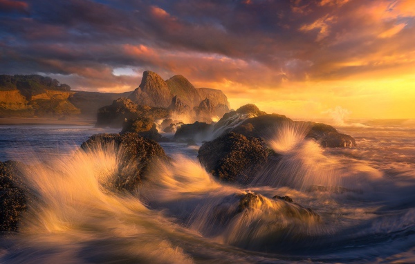 Волны разбиваются о камни у побережья в Орегоне