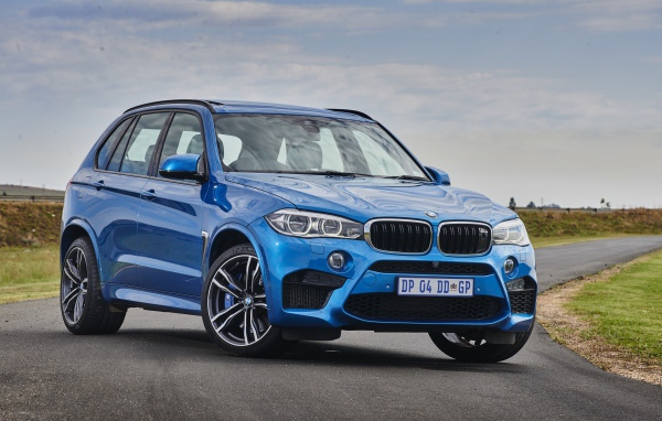 Голубой внедорожник Bmw X5 на дороге