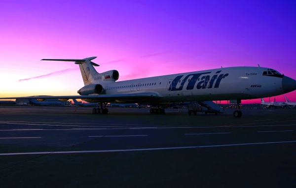 A passenger plane Tu-154 UTair Russian airline on the sunset background