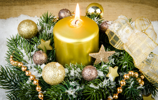 A beautiful burning candle and a wreath at Christmas
