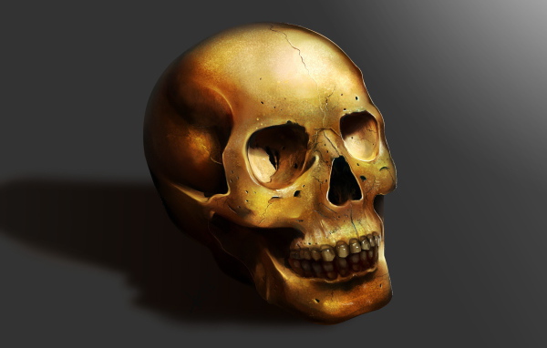 Золотой череп на сером фоне