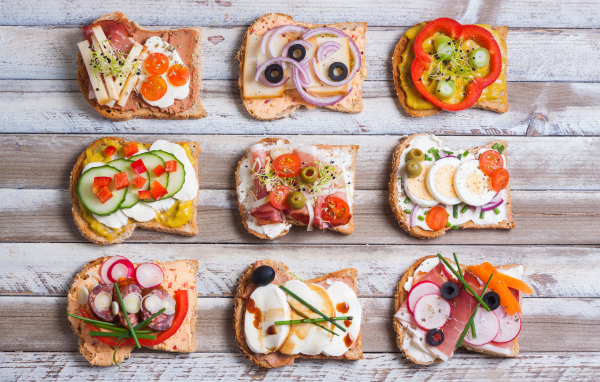 Аппетитные бутерброды на деревянном столе вид сверху