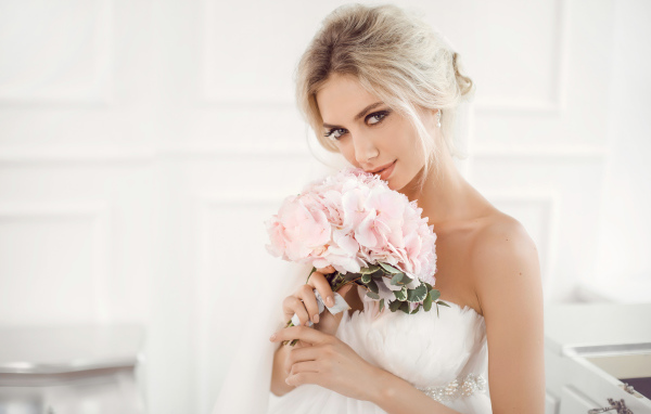 Красивая блондинка невеста с букетом розовых цветов в руках