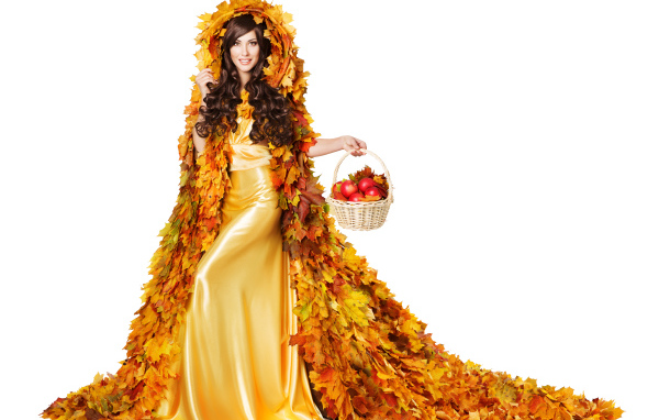Красивая молодая девушка в плаще из желтых листьев с корзиной в руке