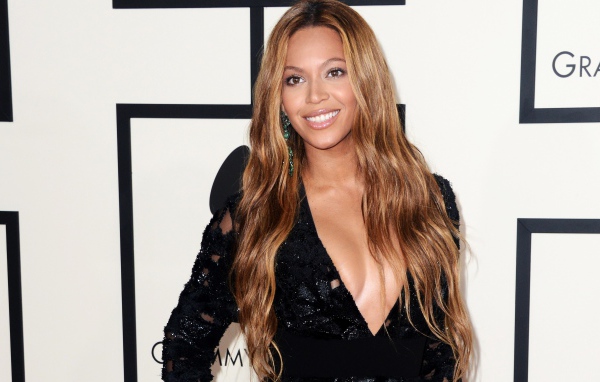 Красивая улыбающаяся певица Бейонсе в черном платье