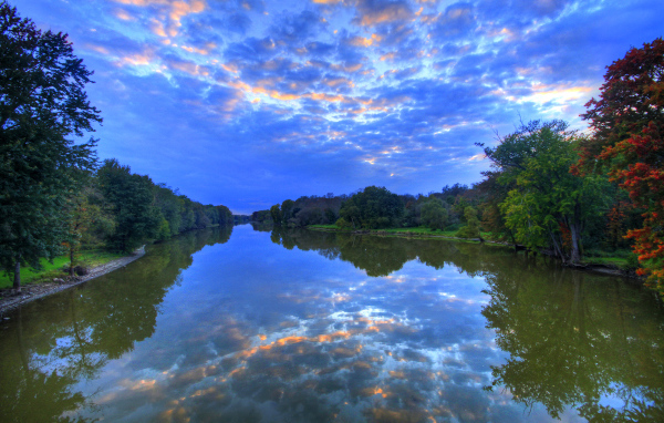 Красивое необычное небо отражается в реке