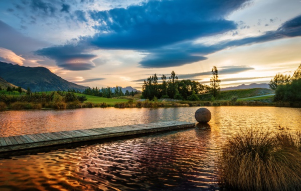 Деревянный мост в озере на закате солнца