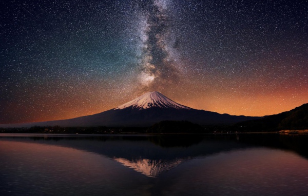 Заснеженная вершина горы на фоне млечного пути 