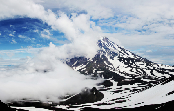 Вулкан Авачинская сопка покрыт белыми облаками, Камчатка. Россия 