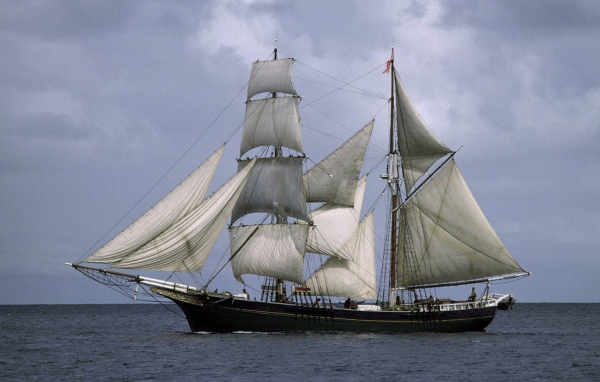 A ship with white sails in the sea