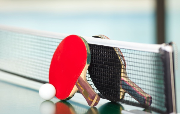 Ракетки для настольного тенниса у сетки  
