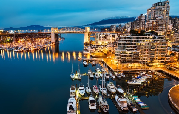 Лодки у причала на фоне ночных огней города Ванкувер, Канада