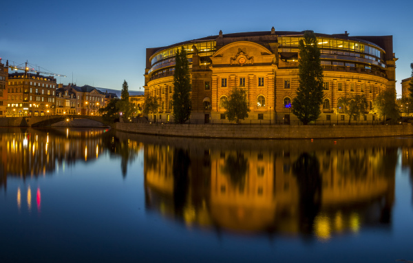 A beautiful building in the evening lights is reflected in the water, Stockholm. Sweden