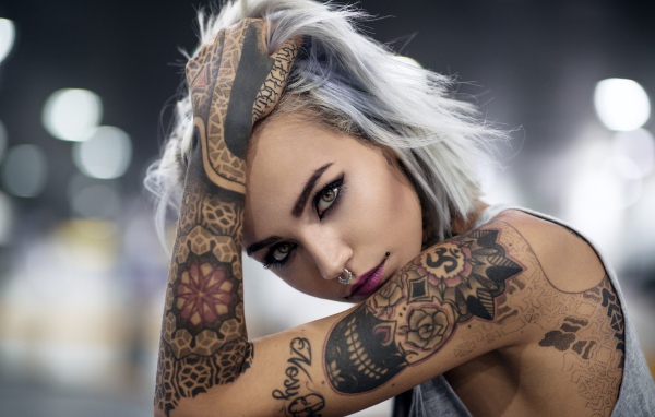 Young girl with tattoos on body