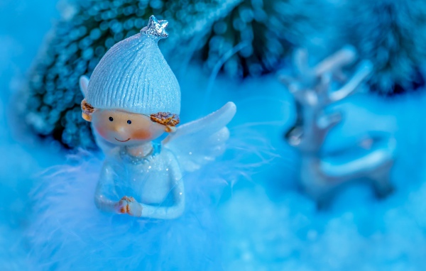 Статуэтка ангелочка на голубом фоне