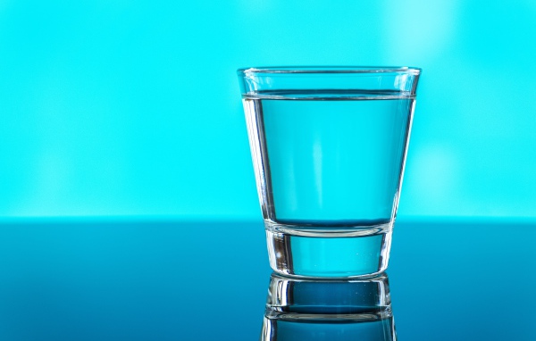 A glass of water on a blue background