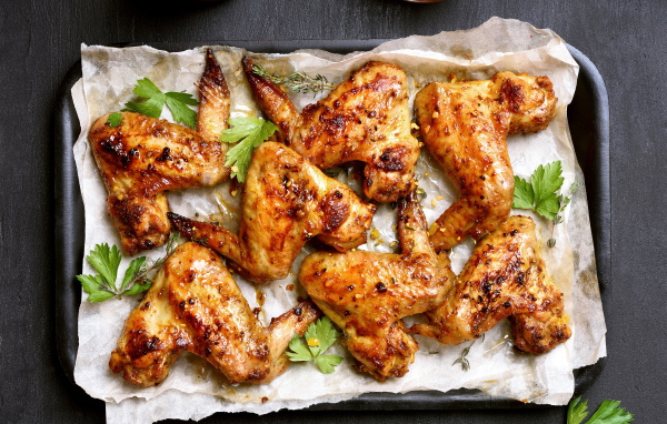 Запеченные куриные крылышки на противне со специями и зеленью
