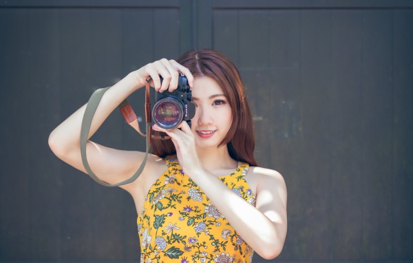 Девушка азиатка с фотоаппаратов в руках