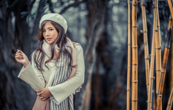 Красивая девушка азиатка в пальто с беретом на голове