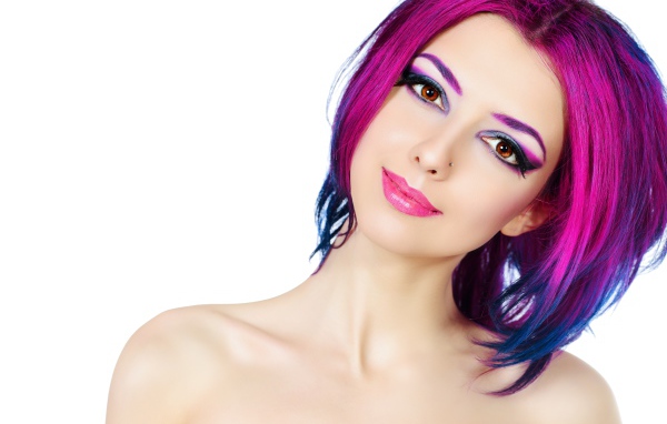 Красивая девушка с ярким макияжем и крашеными волосами на белом фоне