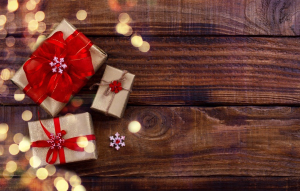 Holiday gifts on wooden background