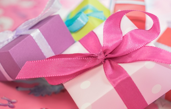 Pink gift with ribbon bow close up