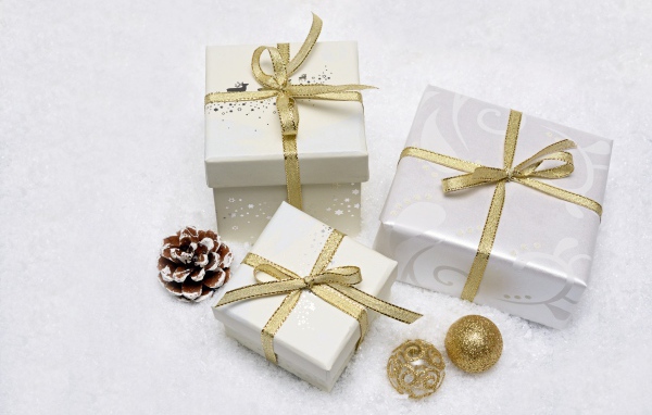 Three gift boxes with golden ribbon bows