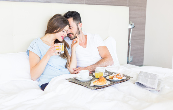 Couple in love with breakfast in bed
