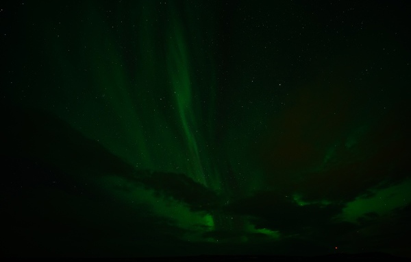 Зеленое северное сияние в звездном небе