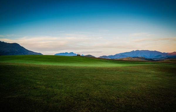 Зеленый луг на фоне красивого неба