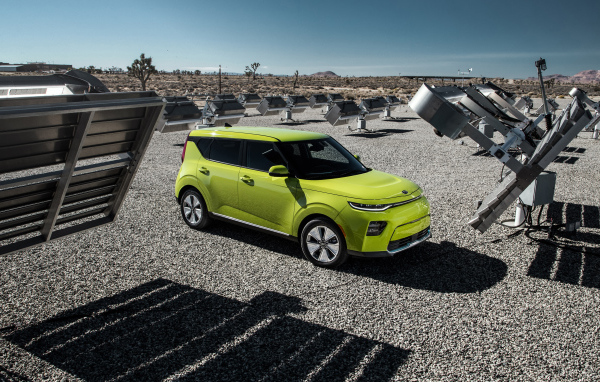 Салатовый автомобиль Kia Soul EV, 2020 года на асфальте