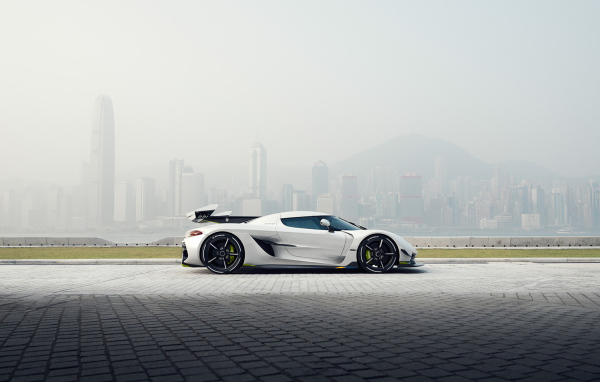 Белый автомобиль  Koenigsegg Jesko, 2019 года на фоне туманного города